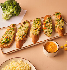 Crispy garlic toast with melted cheese and vegetables for restaurant menu
