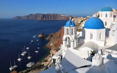 Oia Santorini's iconic blue-domed churches overlooking the island's volcanic caldera and the Mediterranean Sea	
