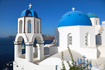 Oia Santorini's iconic blue-domed churches overlooking the island's volcanic caldera and the Mediterranean Sea	
