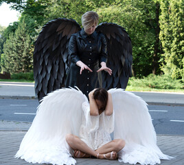 Two girls with black and white wings