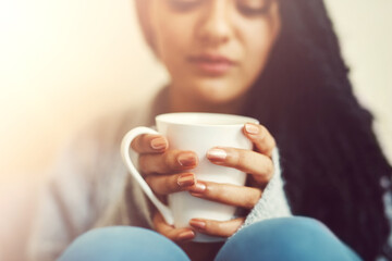Hands, home and woman with coffee for relax, rest and comfort in morning. Apartment, house and female person with warm drink, beverage and tea for chill, peace and calm in living room on weekend