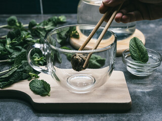 Chinese Tea Flower Bud Blooming in Glass tea cup
