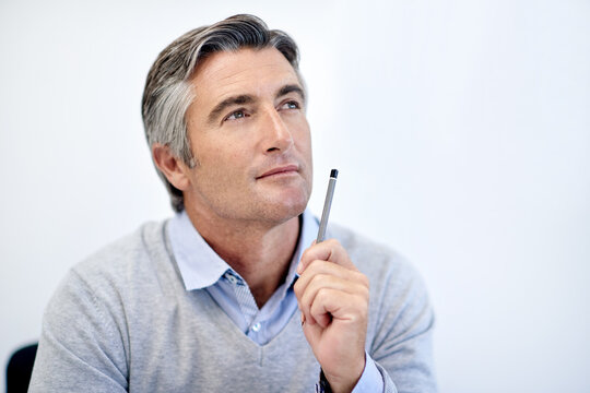 Mature, businessman or thinking with pencil in studio for choice, decision or problem solving on a white background. Man, employee or wonder with contemplation for business solution or ideas on space