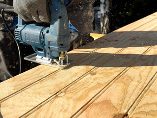 Crafting precision with a jigsaw on a bright day in a tranquil workshop