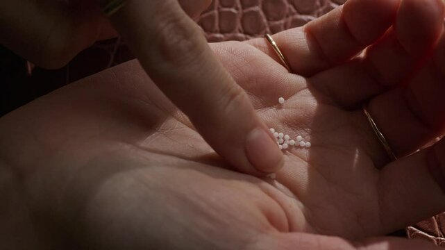 Globolis on hand touched with finger.