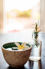Spa, bowl and water with flower for zen, tranquility or luxury salon for aroma, essence or therapy. Closeup, empty and natural plant with leaves for calming aesthetic, serene or relaxation at resort