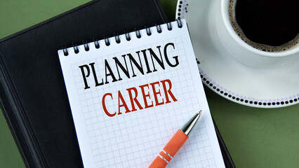 PLANNING CAREER - words in notebook on green background with cup of coffee