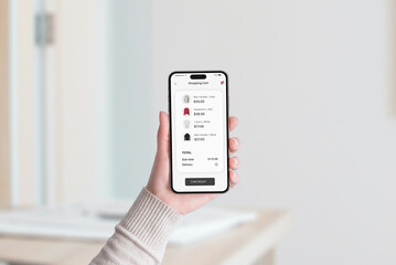 Smartphone screen showing a shopping cart filled with clothing items, total price, and a 'Checkout'...