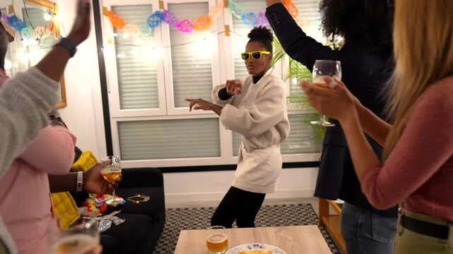 Multiethnic friends dancing at reunion party