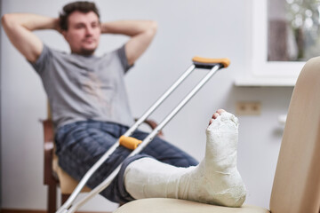 Close up of a young man's Plaster leg cast and after a running injury or fall