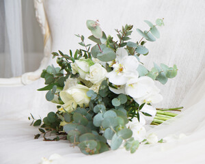 elegant stylish bridal bouquet wedding bouquet in white and green tones contains roses, orchids, eucalyptus branches