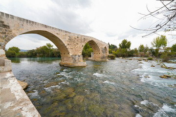 Seljuk bridge in Aspendos. The Eurymedon Bridge. Aspendos Yolu Belkis Mevkii. Turkey. Crooked...