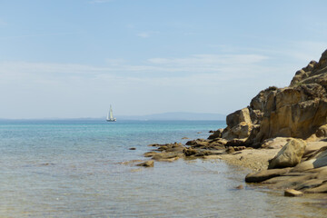 sailboat on the horizon in a sea bay