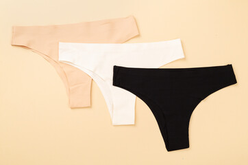Set of woman panties on color background, top view