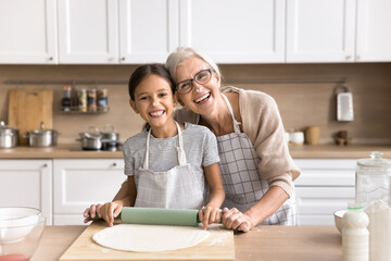 Funny cuisine. Happy joyful mature granny preteen age girl grandchild posing for cute family...