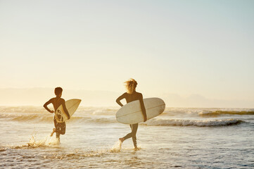 Beach, surfboard and men running, sunset and water sports in fun, healthy lifestyle or fitness. Male athletes, friends or surfers on tropical island, holiday and seaside vacation for break or mockup