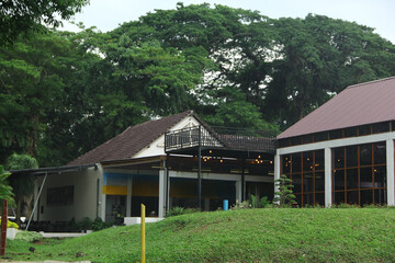 The sturdy building stands. The cafe in this park is covered with green grass which can be seen during the day
