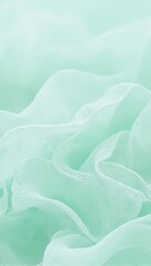 Obraz premium Elegant mint green chiffon fabric with transparent layers creating a gradient effect