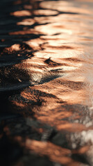 Golden sunset reflection on rippling water surface