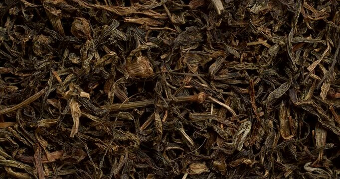 Dried Jimbu herb background texture - herb belonging to the onion family, used extensively in Nepal and in some Himalayan states of India. Close-up. Zoom in while rotating.