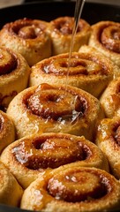 Delicious cinnamon roll caramelizing in skillet