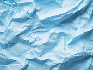 Obraz premium Crumpled light blue paper with deep folds and intricate shadows