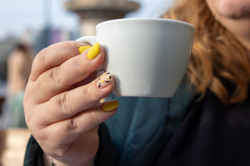 A cup of aromatic coffee held in hand