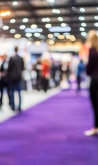 Blurred people networking at a busy conference expo event with purple carpet