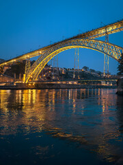 Obraz premium The iconic Dom Luís I Bridge, illuminated against the night sky, stands as a symbol of Porto s industrial heritage and architectural beauty.