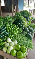 Fresh green vegetables displayed on wooden table at outdoor market