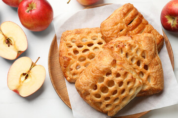 Delicious puff pastries and apples on white marble table, top view