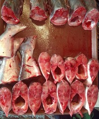 Fresh Fish Cuts on Wooden Cutting Board Ready for Market Sale