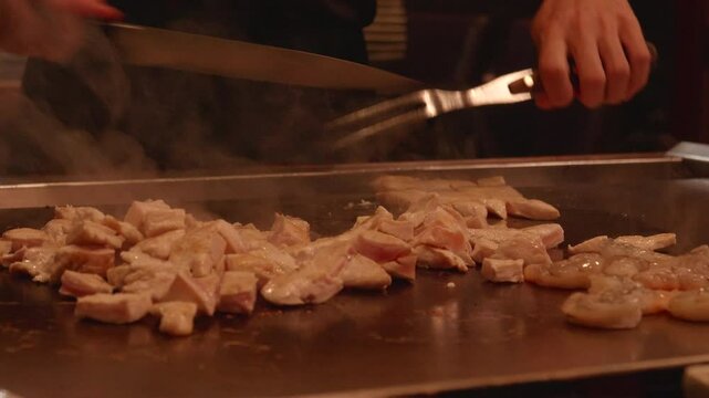 Teppanyaki Chef Slicing up Chicken