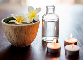 Flower, spa and aromatherapy candles on table with water bowl, peace and natural fragrance. Holistic health, hospitality service and counter with essential oil for self care at luxury wellness salon
