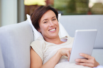 Sofa, portrait and woman with tablet for ebook, online entertainment and web subscription at home. House, female person and relax with smile for interactive app, social media and game in living room