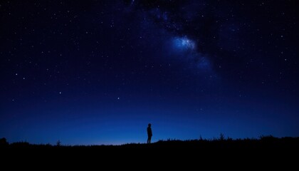 Person gazing at starry night sky with milky way visible