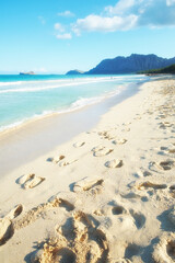 Footprints, sand and beach coast for tourism, holiday trip and resort by tropical island of Hawaii. People, peace and travel to waves of Honolulu in nature, ocean vacation and sustainable adventure
