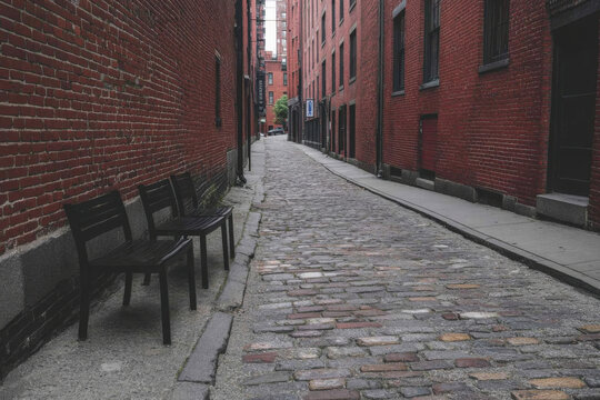 A brick walkway with two benches on it