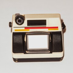 A classic Polaroid camera taking a picture of a blank space, with a space for your own text or image.