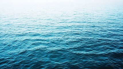 Obraz premium Calm Blue Ocean Waves Under Clear Sky for Tranquil Nature Scenes