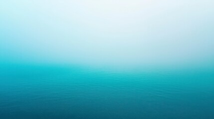 Obraz premium Tranquil Sea Surface with Soft Mist in Calm Blue Tones