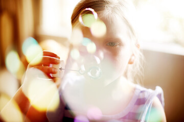 Girl, child or blowing bubbles with bokeh for sensory stimulation, cognitive development or...