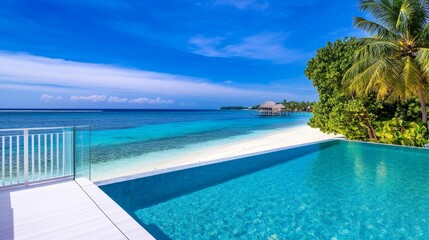 Obraz premium Serene beachfront view with crystal-clear pool, tropical palm trees, and distant huts under a blue sky