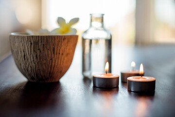 Spa, body care and essential oil with flower in bowl for aromatherapy, wellness massage and luxury treatment. Tranquil setup, health salon and empty room for stress relief, pamper and hospitality