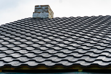 Metal roof and a brick chimney ready for sheathing with a metal profile