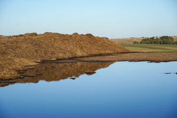Agricultural field with manure piles, preparing for the season