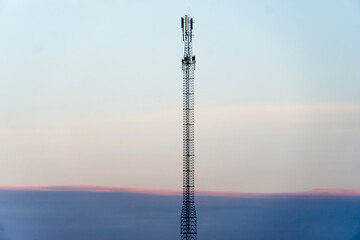 High communication antenna on the background of the sunset