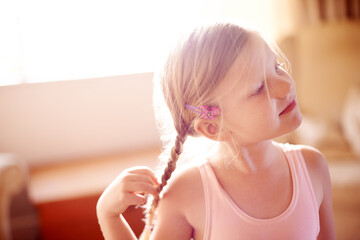 Ballet, development and thinking with girl in living room of home for practice, recital or rehearsal. Dance, grace and growth with happy ballerina child in apartment for future, planning or vision © Mikolette M/peopleimages.com