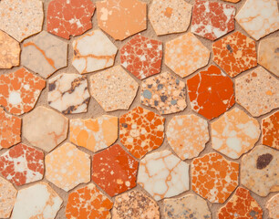 Hexagonal Breccia Pernice marble mosaic with angular fragments in terracotta tones, ideal for ancient Roman bathhouse restoration texture.
