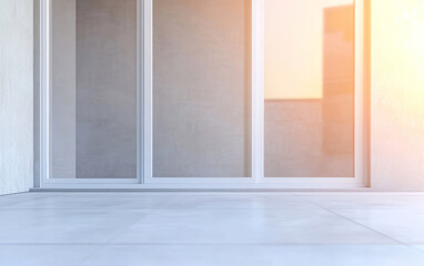 Modern patio with glass doors reflecting sunset light in a minimalist setting